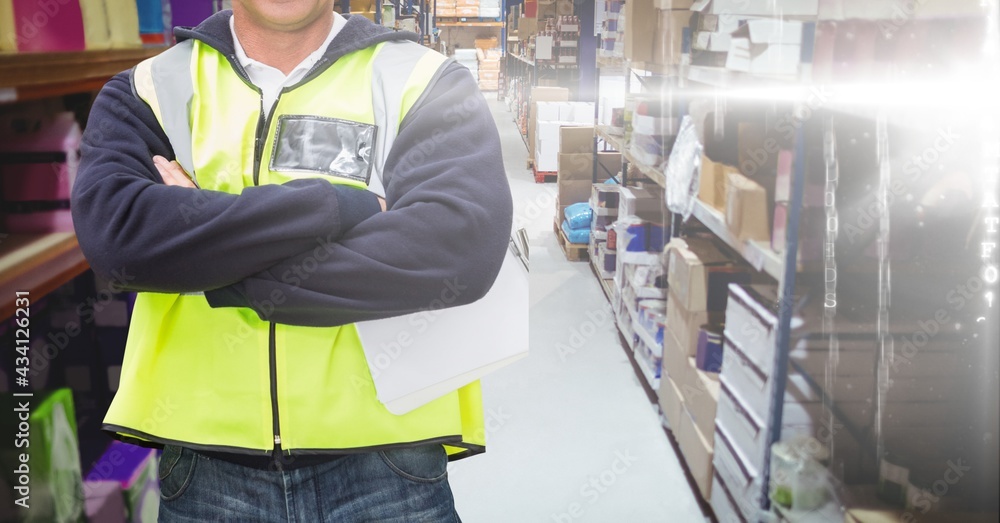 Mid section of caucasian worker crossed arm and wearing yellow vest