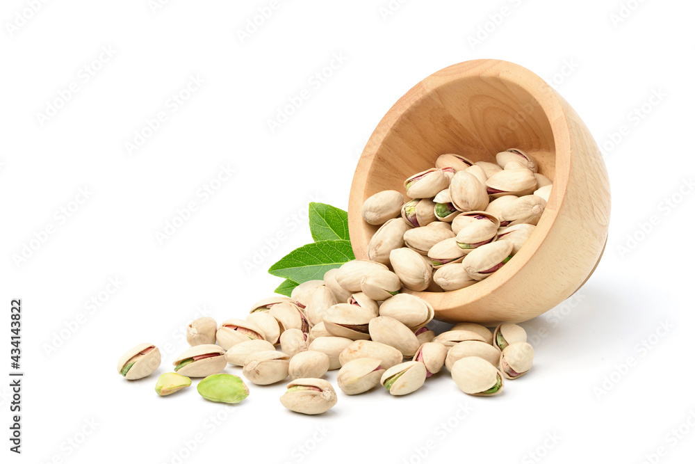 Pistachio nuts with wooden bowl isolated on a white background.