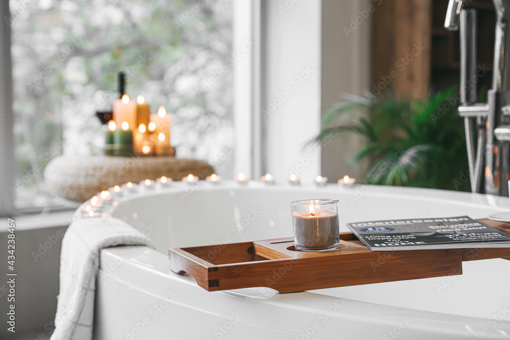 Stylish interior of modern bathroom with burning candles, closeup