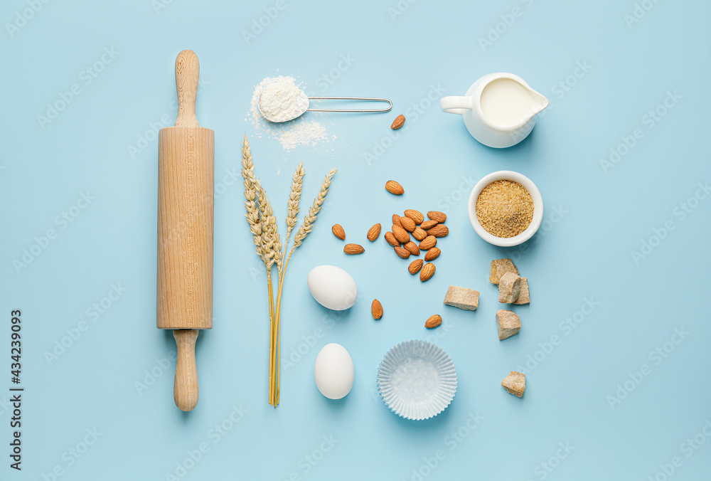 Ingredients for preparing bakery and kitchen utensils on color background