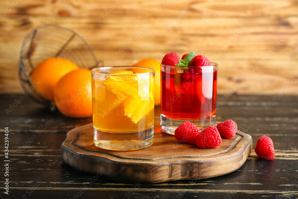 Glasses of tasty jelly on dark wooden background