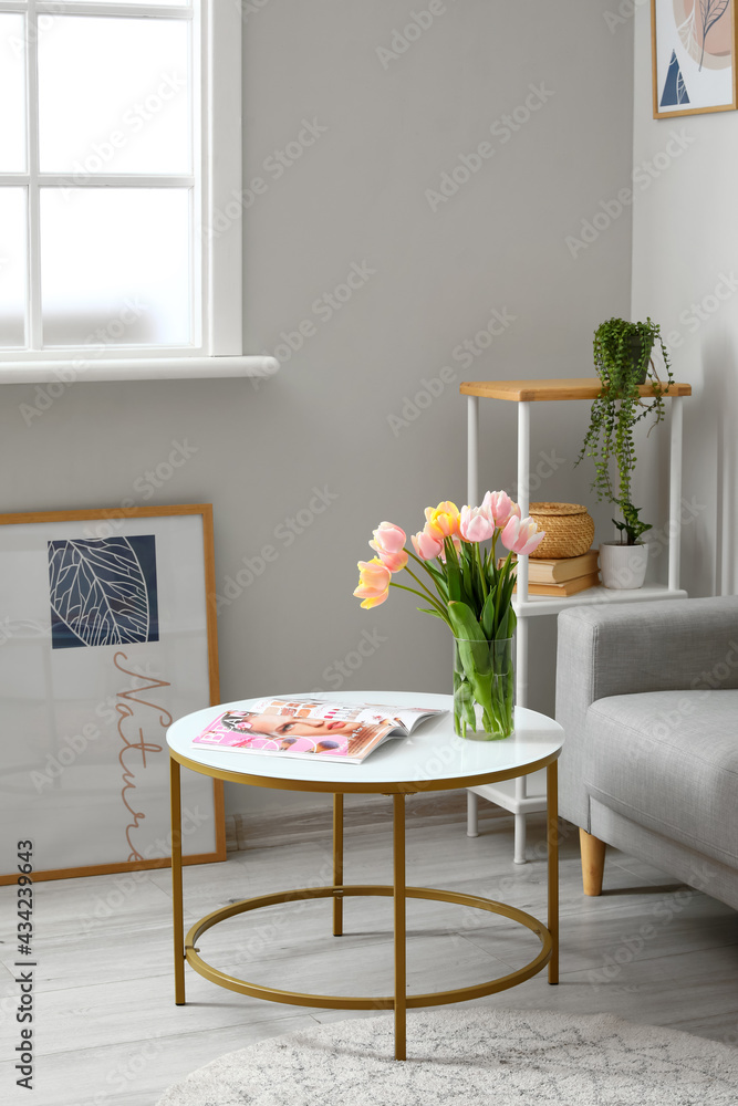 Bouquet of tulip flowers on table in interior of living room