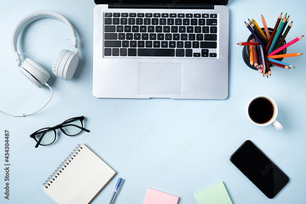 Online learning design concept. Top view of student table with computer, headphone and stationeries.