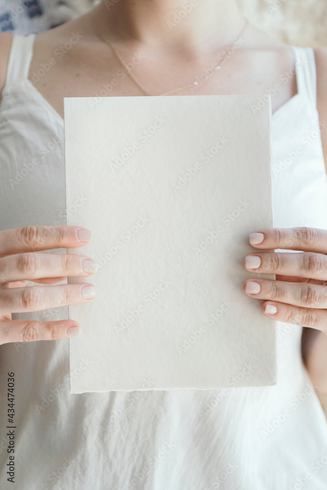 Bride holding a blank white card