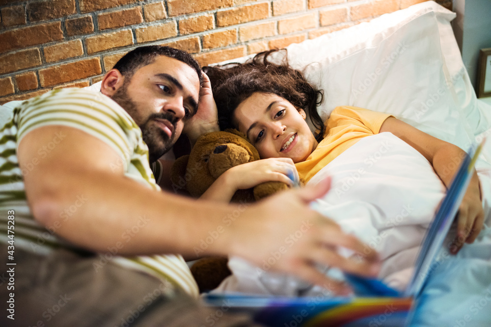 Dad and daughter reads story book