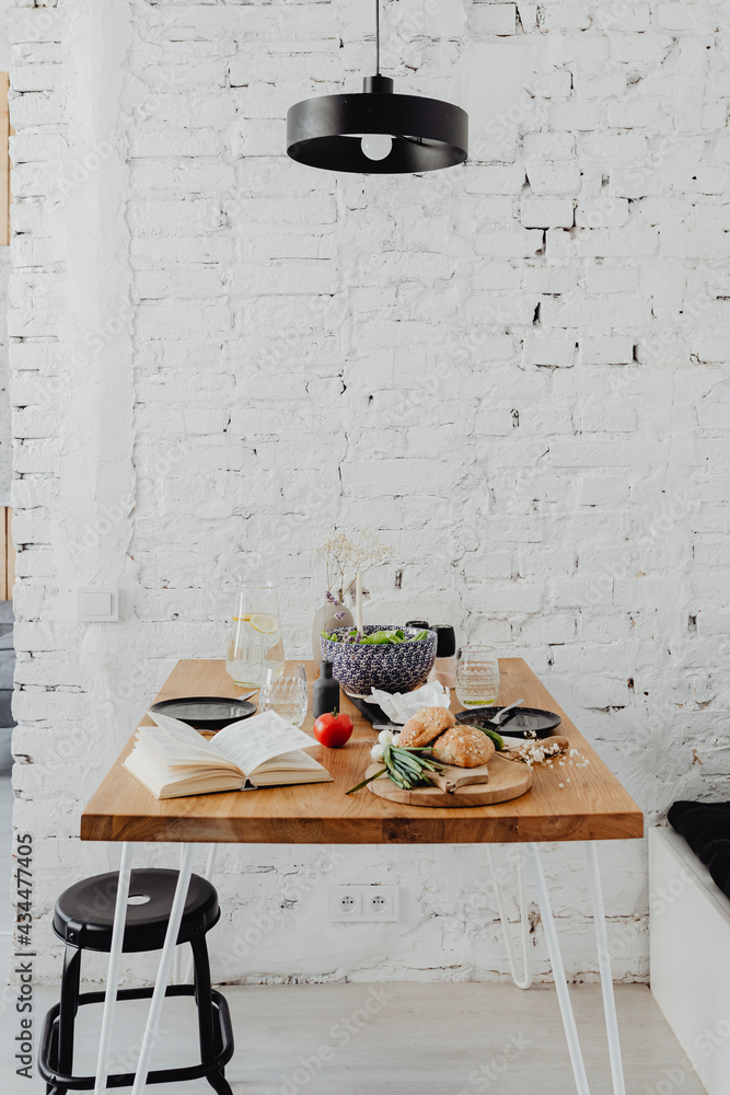 Messy dining table with a book