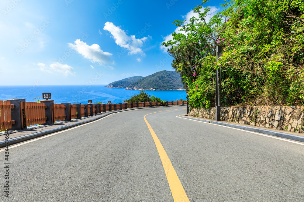 Mountain highway with blue sky and sea landscape.