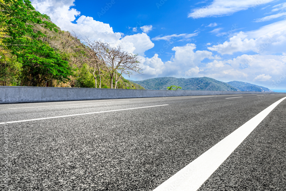 Mountain road landscape under blue sky.