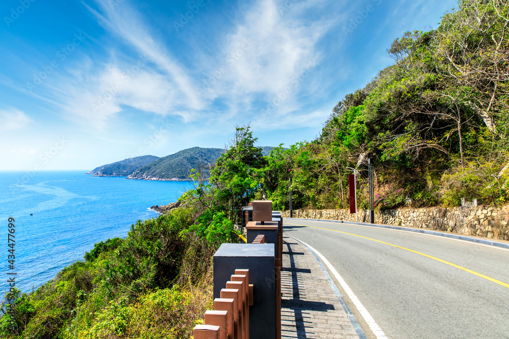 Mountain highway with blue sky and sea landscape.