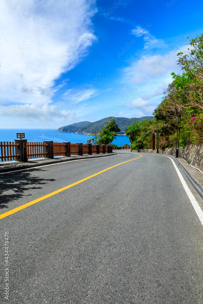 Mountain highway with blue sky and sea landscape.