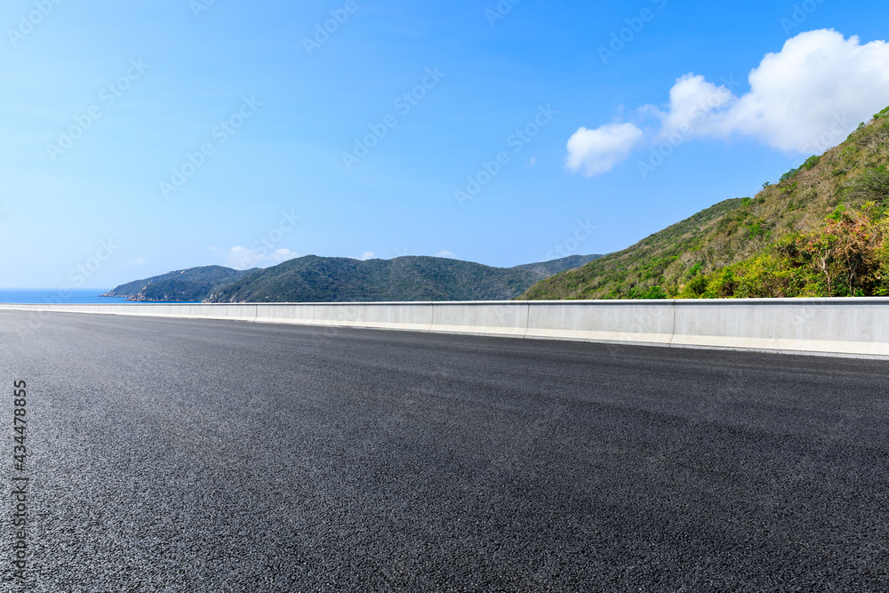 Mountain road landscape under blue sky.