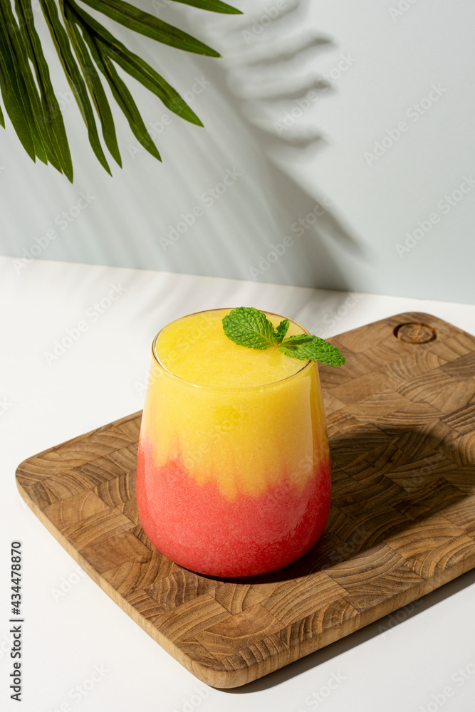 Layered mango and strawberry smoothie