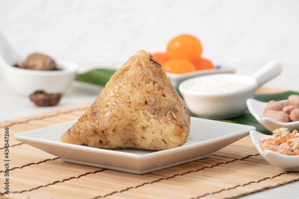 Zongzi. Rice dumpling for Dragon Boat Festival on bright wooden table background with ingredient.