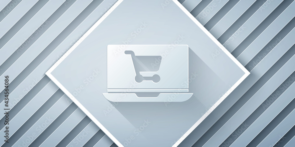 Paper cut Shopping cart on screen laptop icon isolated on grey background. Concept e-commerce, e-bus