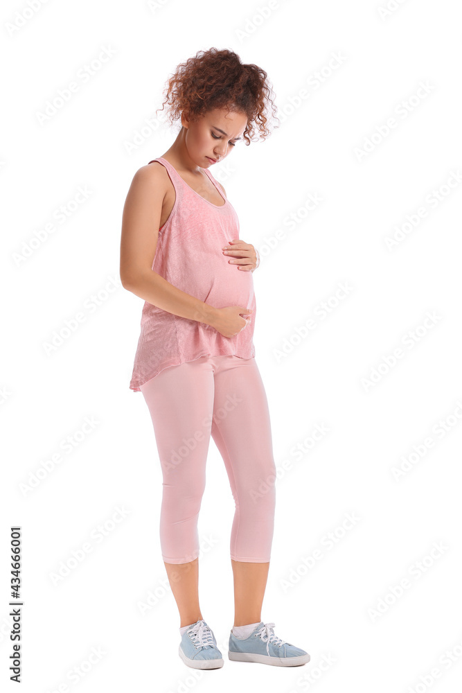 Beautiful pregnant African-American woman on white background