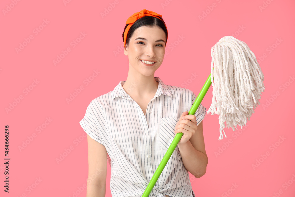 Young woman with floor mop on color background