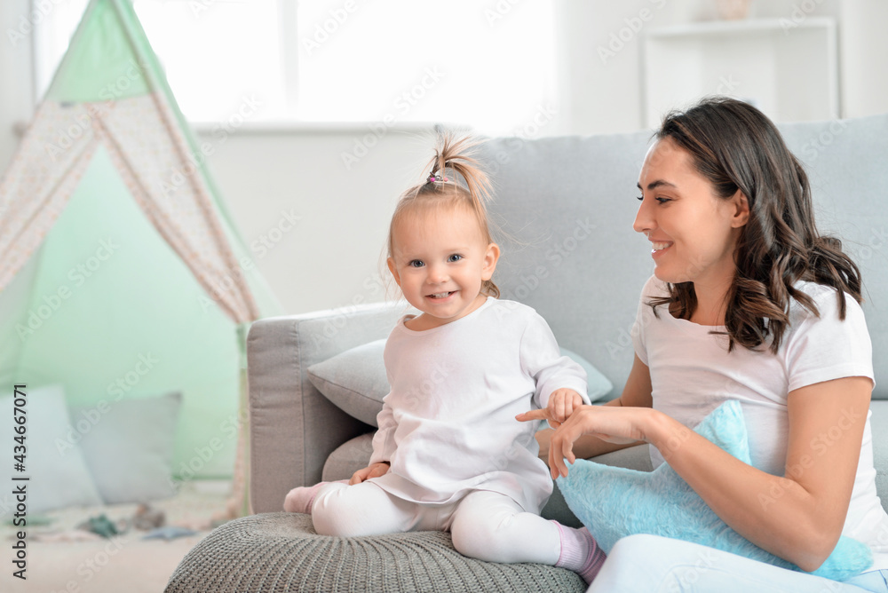 Happy woman and her little daughter at home