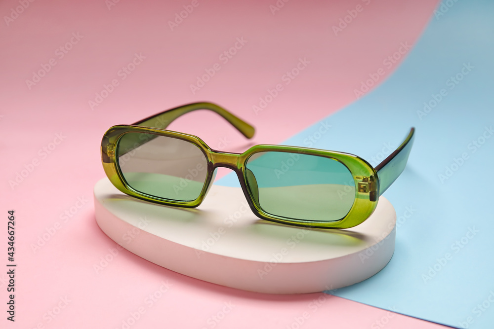 Stylish sunglasses on colorful background, closeup