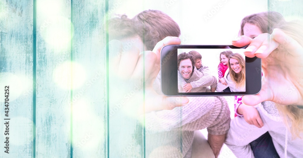 Composition of light circles over happy caucasian family taking selfie with smartphone