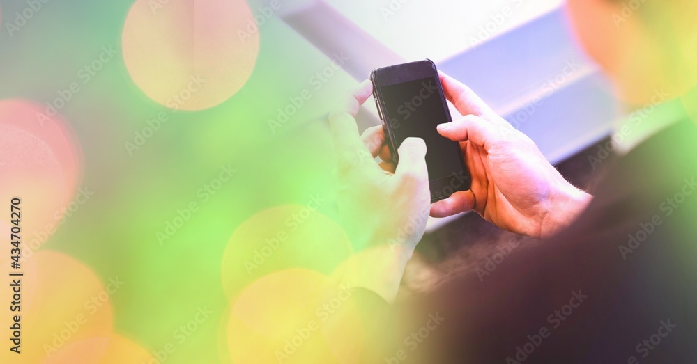 Composition of light circles over caucasian woman using smartphone