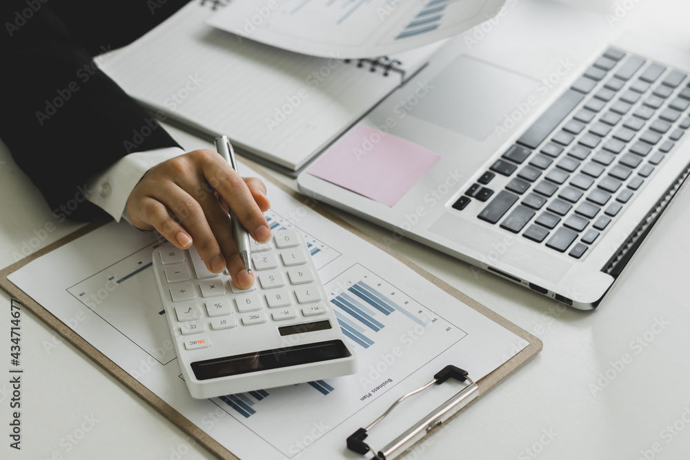 Close up a accountant working about financial with calculator at office to calculate expenses, Accou