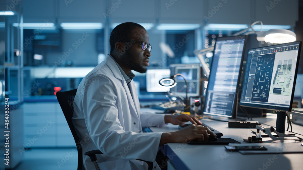 Modern Electronics Development Facility: Male Engineer Works on Computer with CAD Programming Softwa