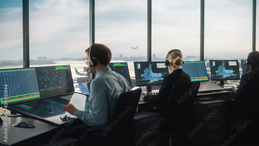 Diverse Air Traffic Control Team Working in a Modern Airport Tower. Office Room is Full of Desktop C