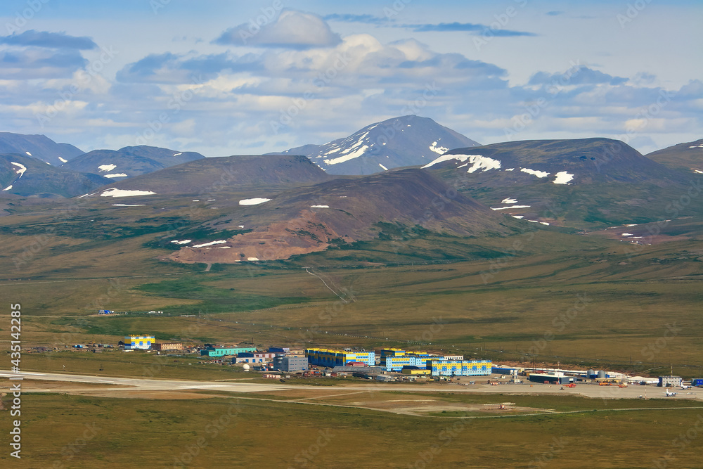 Summer aerial view of the air town and the runway of the arctic airfield. Aerial view of Anadyr Airp