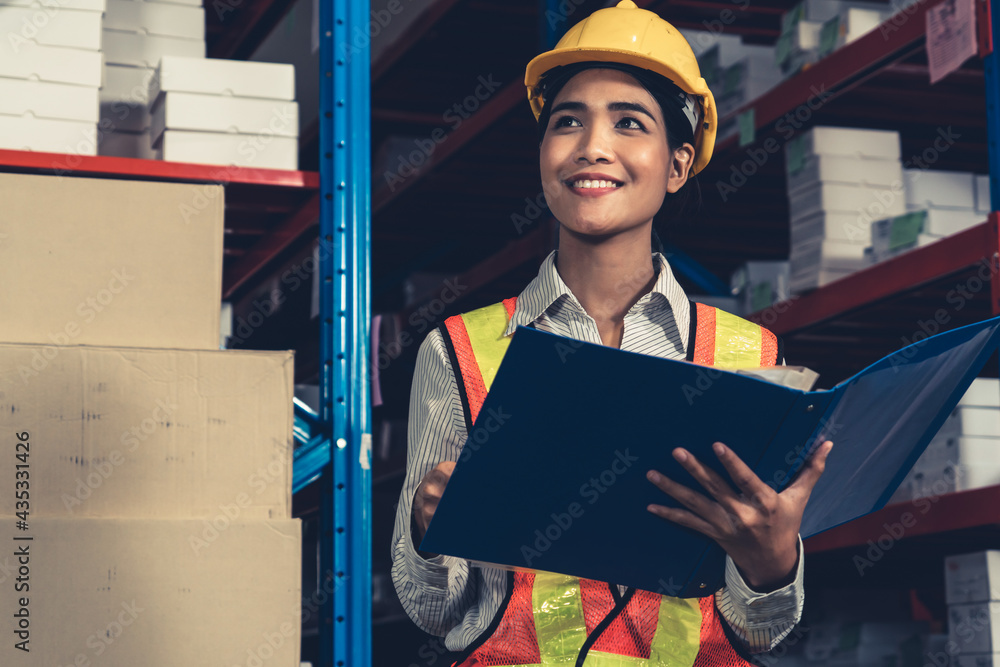 Female warehouse worker working at the storehouse . Logistics , supply chain and warehouse business 