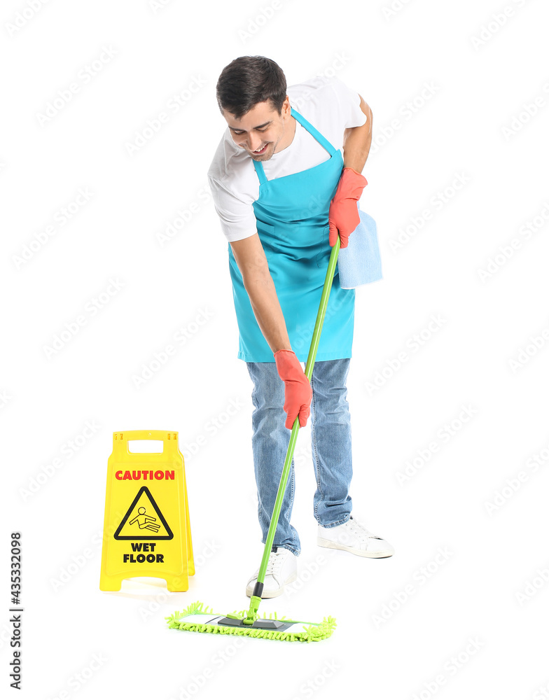 Young man with floor mop and caution sign on white background