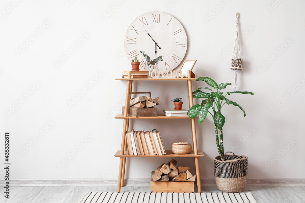 Book shelf with firewood near light wall