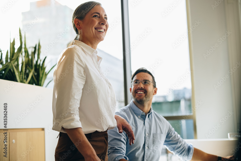 Colleagues smiling while working together