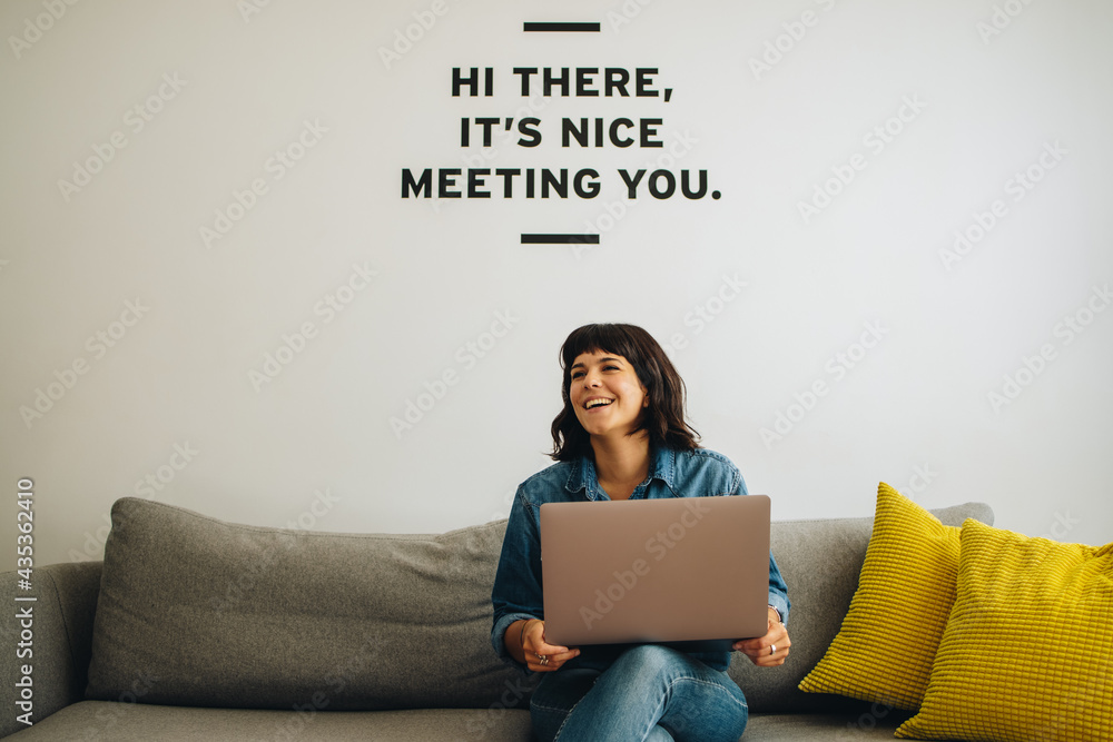 Smiling executive at lobby with laptop