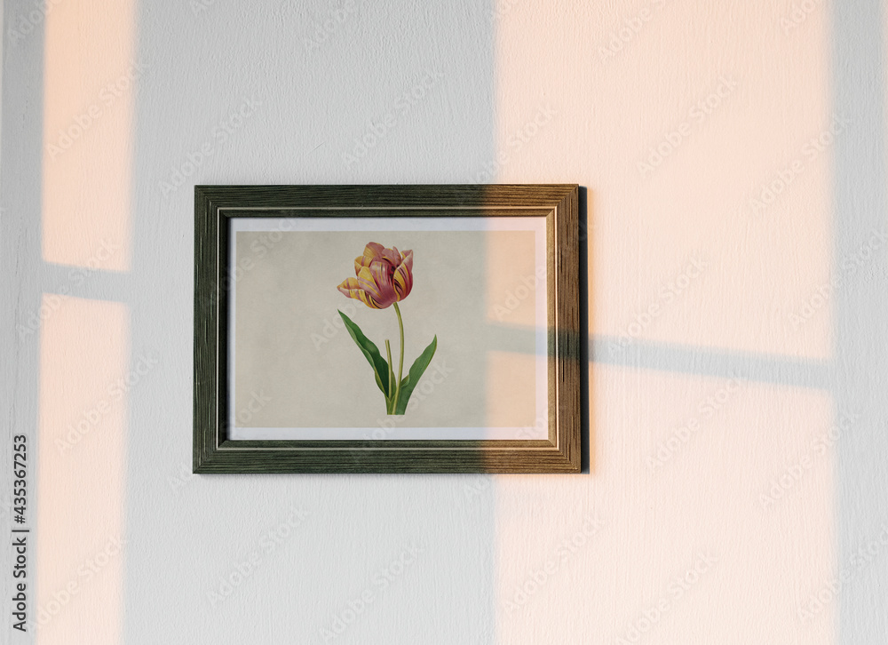 Flower photo frame hanging on white wall