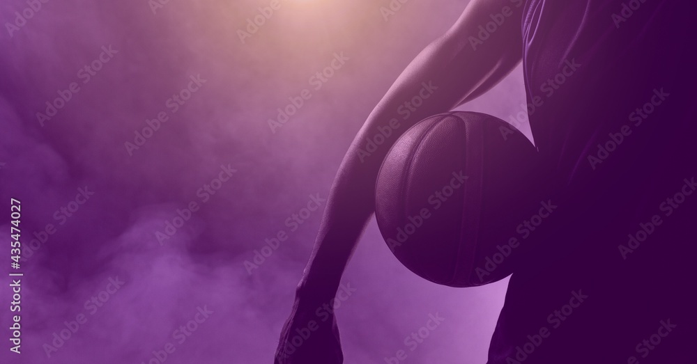 Composition of athletic male basketball player with ball over smoke