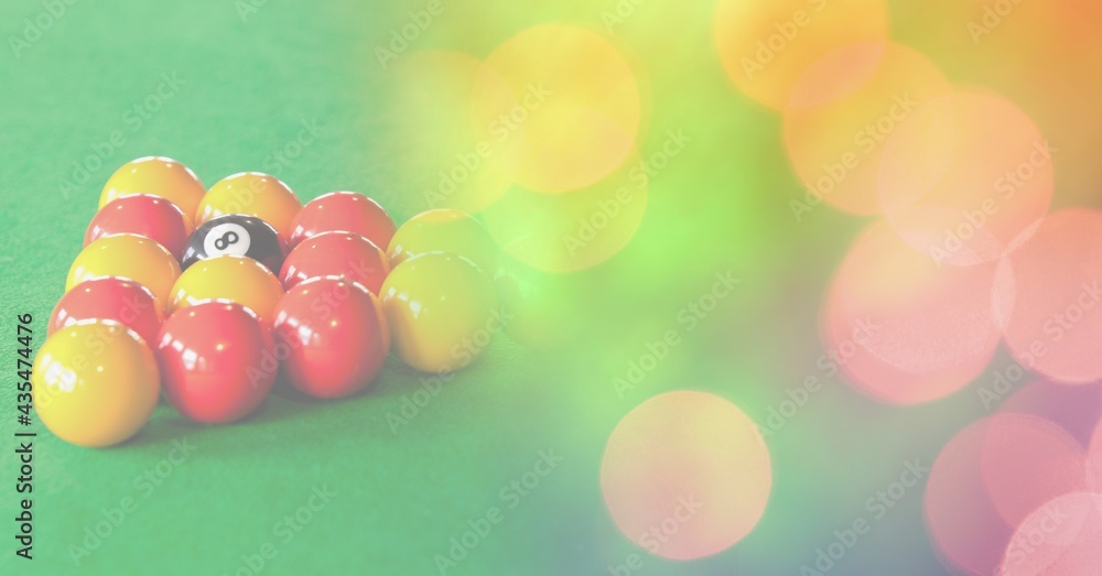 Composition of snooker balls on snooker table with orange and yellow spots in background