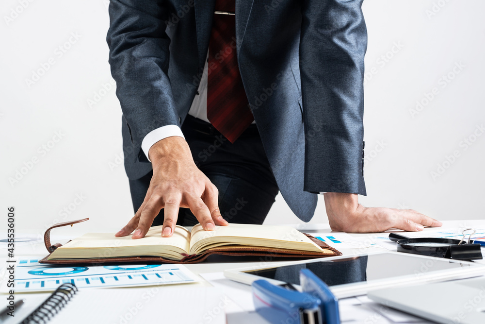 Businessman analyzing financial documents at desk