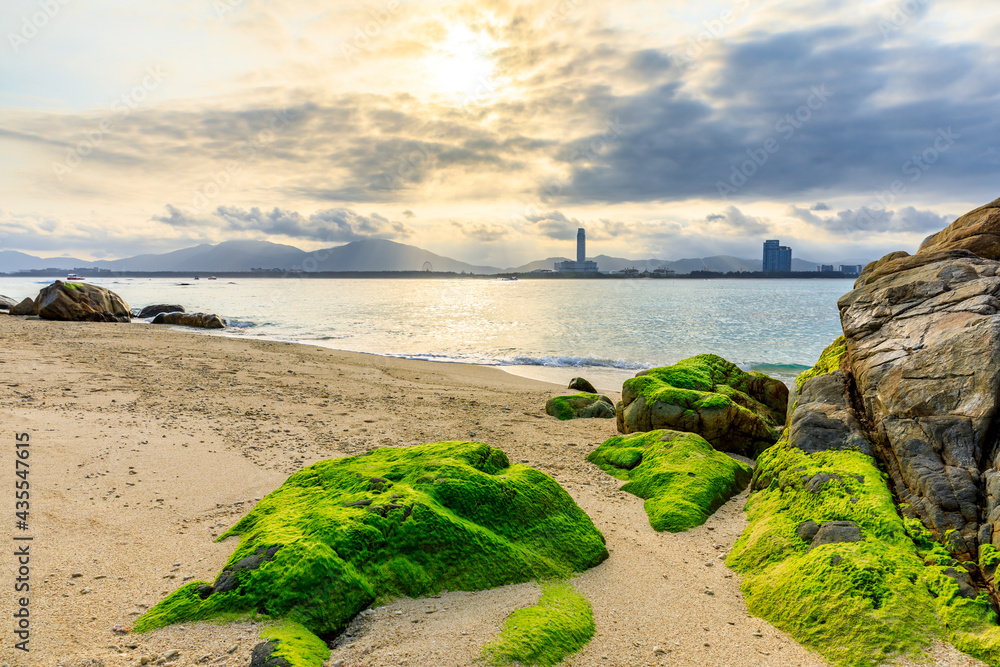 日落时海滩、大海和美丽的云朵的景观。