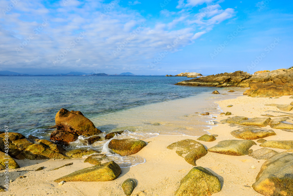 Landscape with beach,the sea and the beautiful clouds in the blue sky.rocks on the beach.