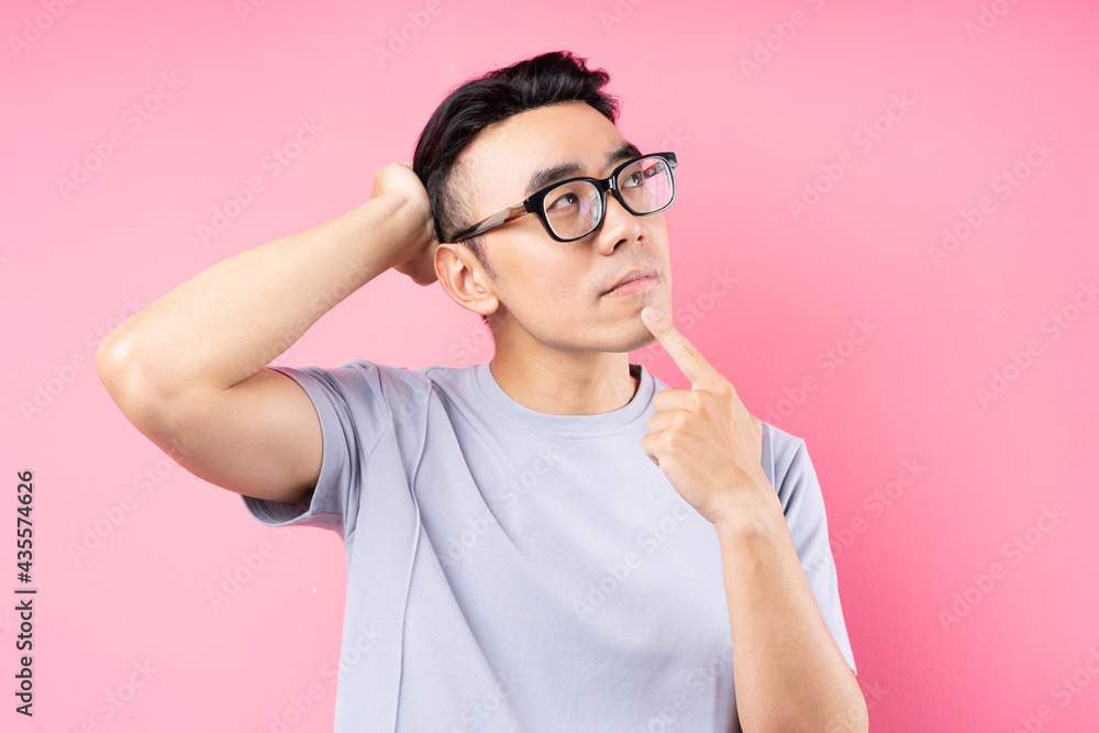 Portrait of Asian man posing on pink background with many expression