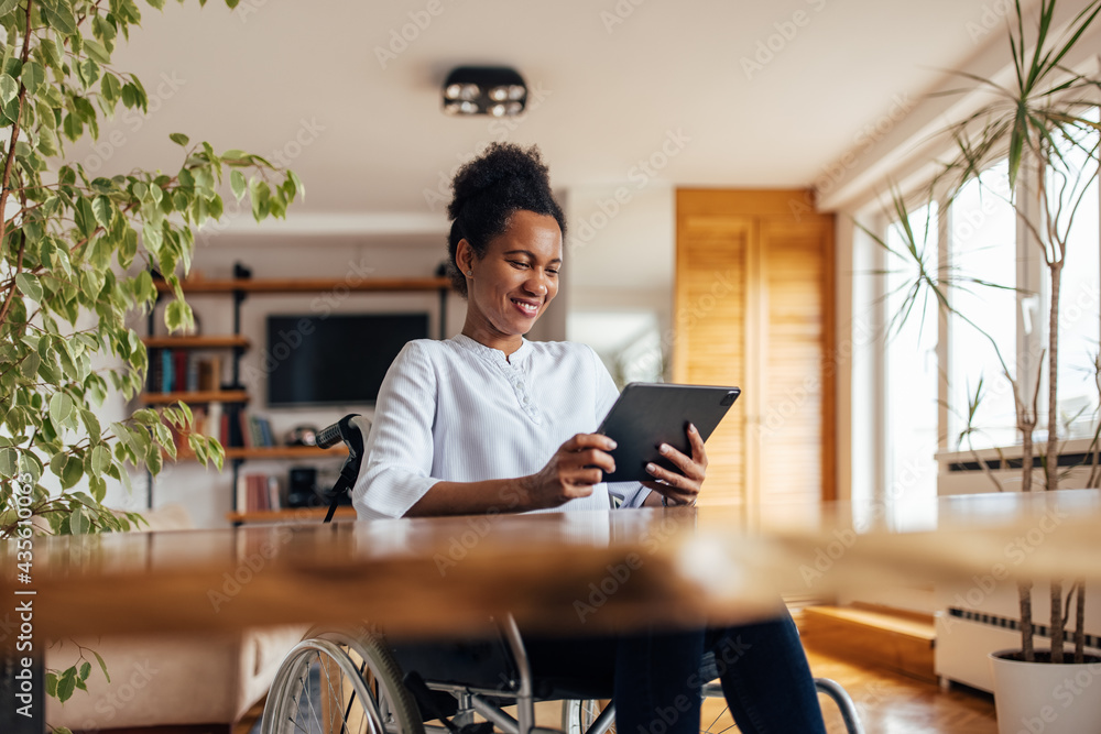 Black woman enjoying at home, reading news online.