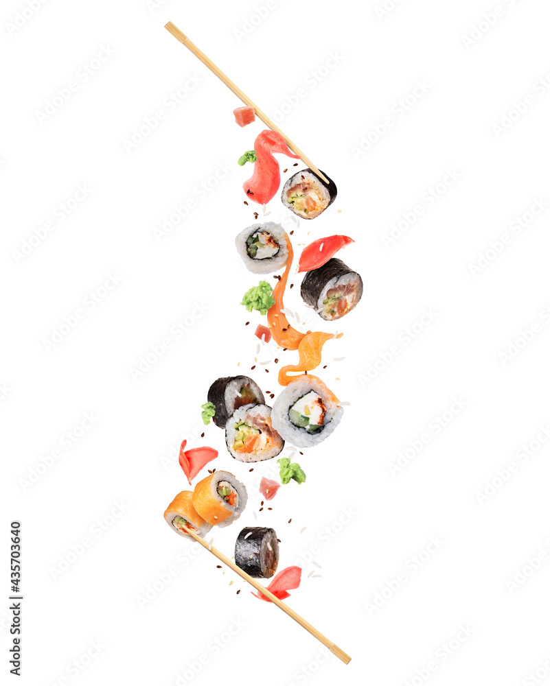 Fresh various sushi rolls with ingredients in the air on white background