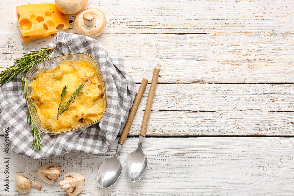 Baking dish with tasty julienne and ingredients on light wooden background