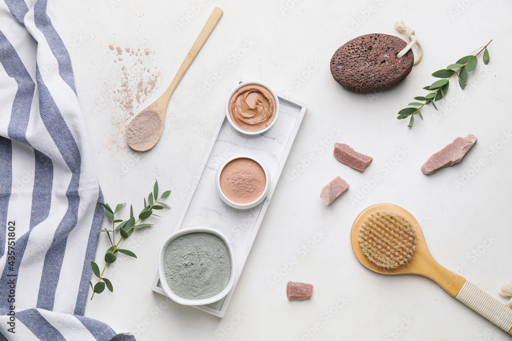 Composition with cosmetic clay and bath supplies on light background