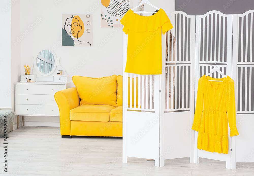 Woman behind folding screen in stylish room