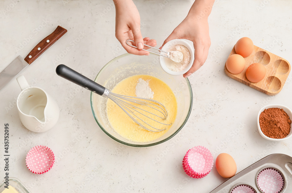 Woman preparing pastry in kitchen