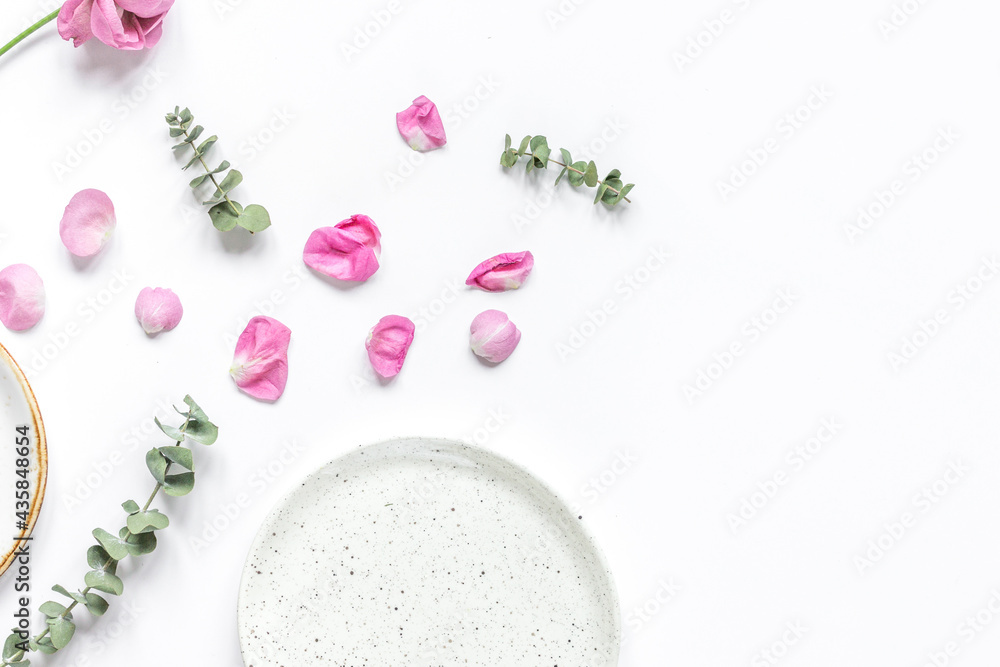 rose, eucalyptus and plates in spring design white background top view mockup