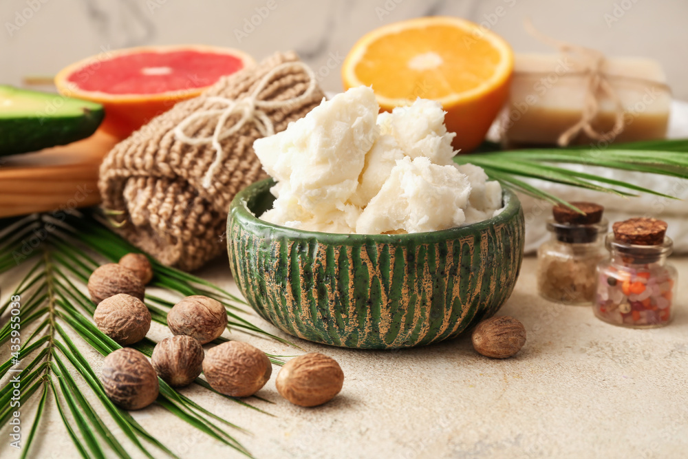 Composition with shea butter and nuts on light background