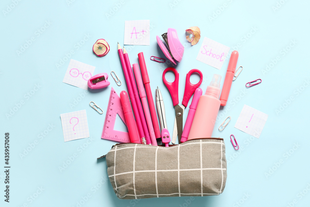 Pencil case and stationery on color background