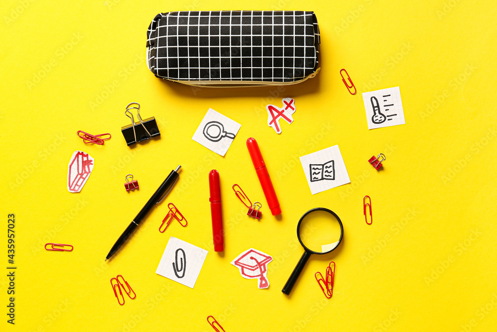 Pencil case and stationery on color background